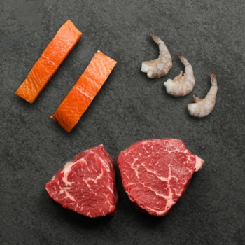 overhead image of shrimp, salmon, and steak