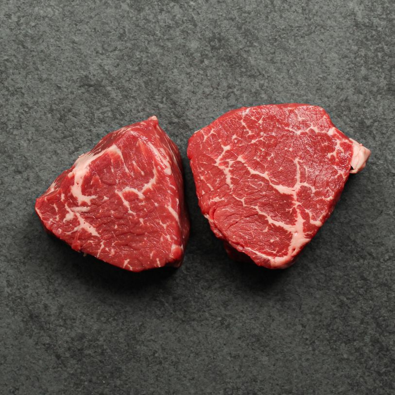 Overhead image of two, 6 oz baseball medallions cut from AAA Canadian beef.