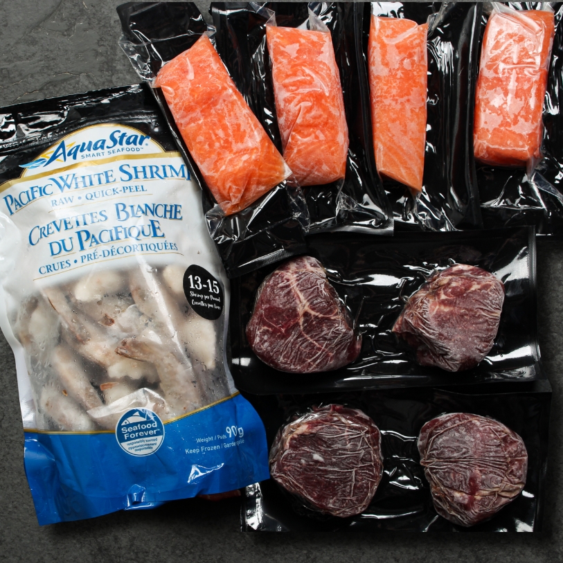 overhead image of shrimp, salmon, and steak in package