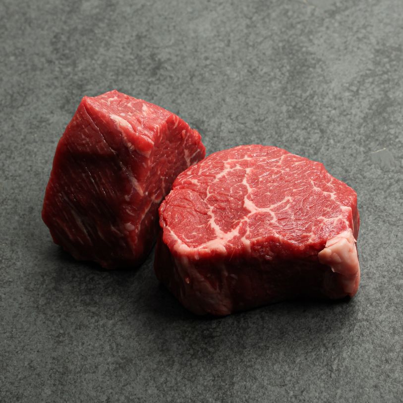 Angled image of two, 6 oz baseball medallions cut from AAA Canadian beef.