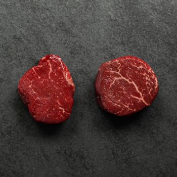 overhead image of two raw beef filet mignon steaks