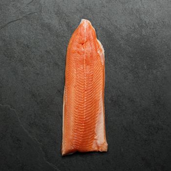 Overhead image of a raw, bright orange fillet of Arctic Char