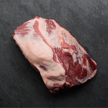 Overhead image of the fatty side of a raw boneless pork butt roast