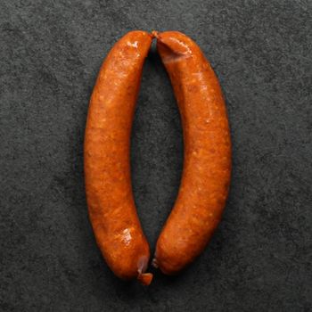 overhead view of two, raw european style hot honey sausages