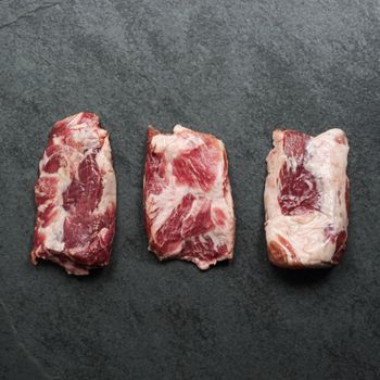 overhead view of three raw pieces of Iberico pork pluma