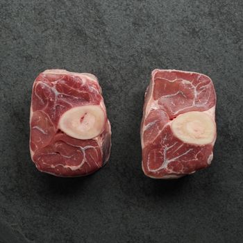 overhead view of w raw pieces of veal osso buco