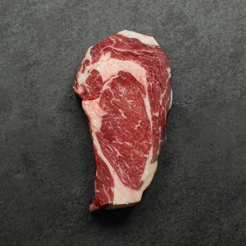 overhead view of a raw dry aged rib eye steak