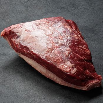 side view of a raw AAA beef picanha roast