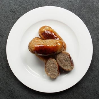 overhead view of 3 cooked classic English breakfast banger sausages