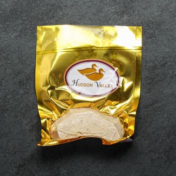overhead view of a vacuum-packaged slice of raw foie gras