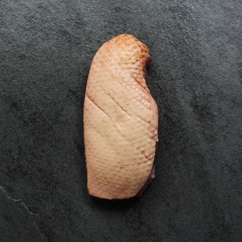 overhead view of the fatty side of a piece of raw duck magret