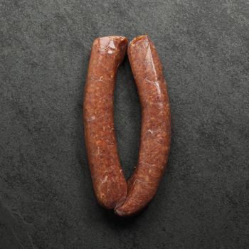 overhead view of two raw Iberico pork and cranberry sausages