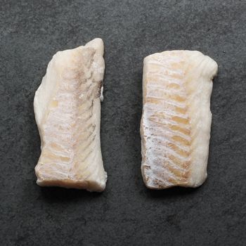 overhead view of two pieces of raw haddock filets