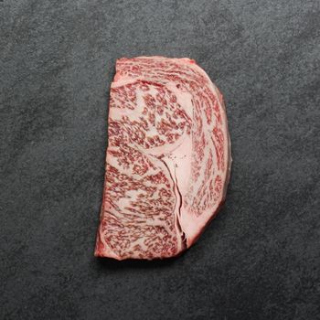 Overhead view of a heavily marbled wagyu rib eye steak.
