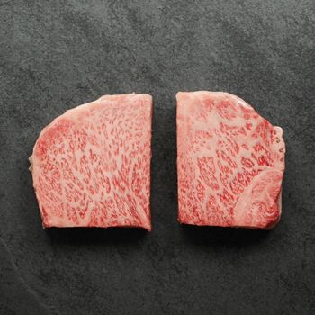 overhead view of two raw Japanese A5 wagyu New York Steaks - California cut