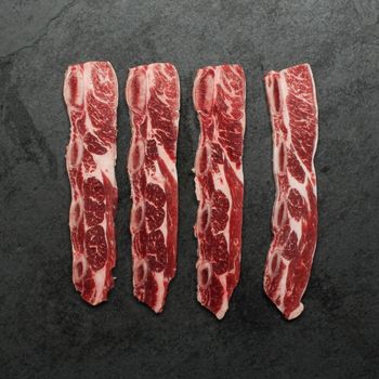Overhead view of raw sliced chuck short ribs.