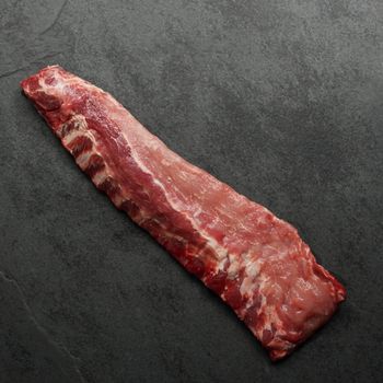 overhead image of a raw rack of pork back ribs