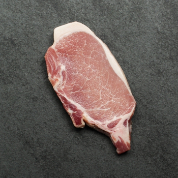 Overhead image of uncooked bone-in pork chop sourced in Canada.