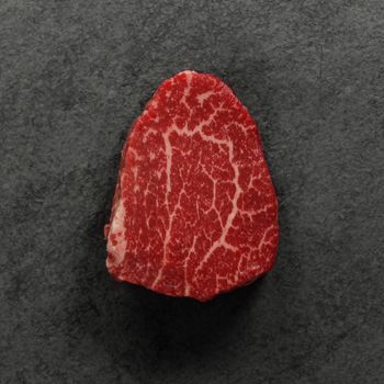 overhead view of a raw heavily marbled American-wagyu beef hybrid filet mignon