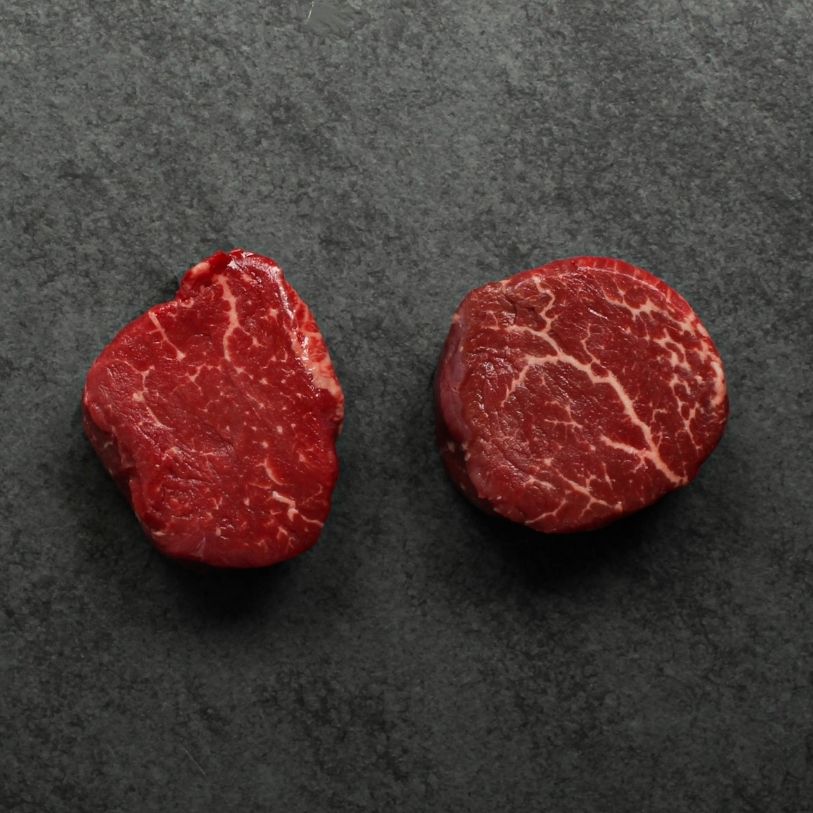 overhead image of two raw beef filet mignon steaks
