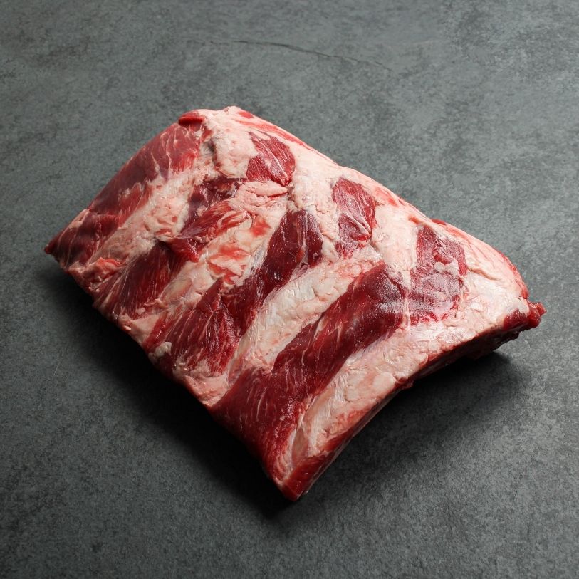 overhead view of a halved rack of raw beef back ribs