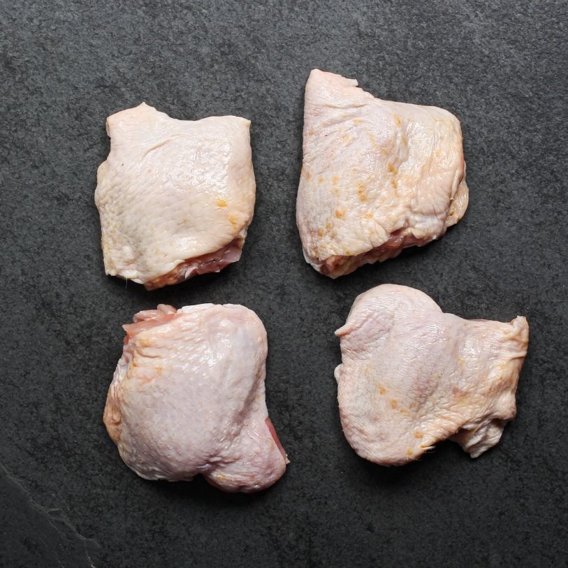 overhead view of 4 raw bone-in, skin-on chicken thighs