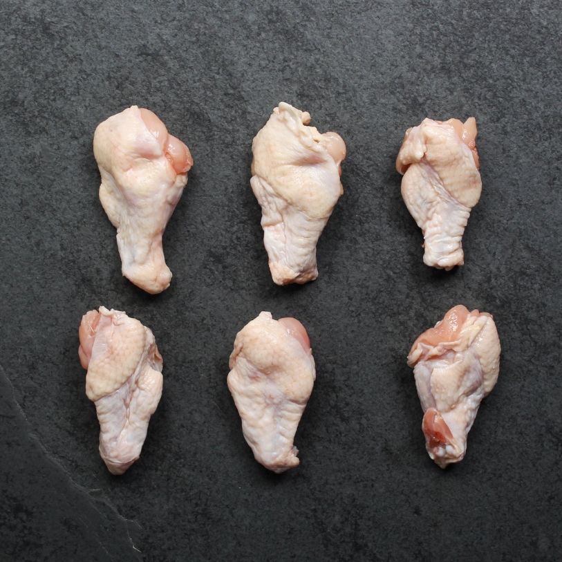 overhead view of 6 raw chicken wing fryer drumette