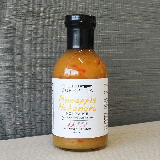 glass bottle of pineapple habanero hot sauce