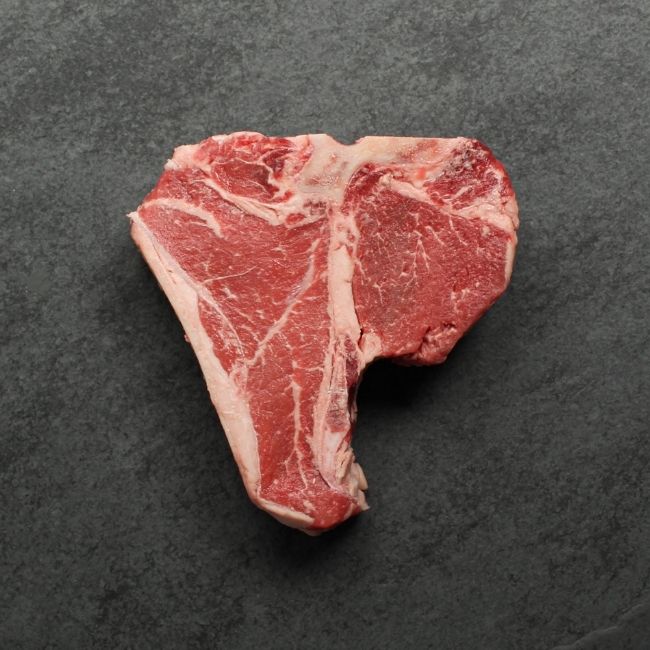 overhead image of a raw T-bone steak