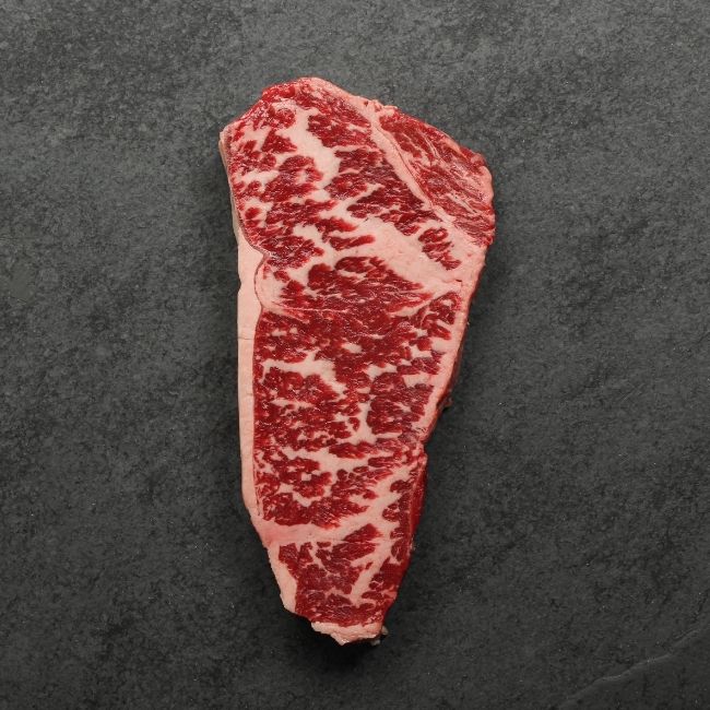 overhead image of a heavily marbled Australian wagyu new york steak