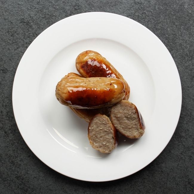 overhead view of 3 cooked classic English breakfast banger sausages