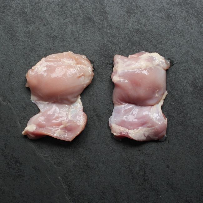 overhead view of two raw boneless skinless chicken thighs