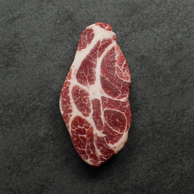 overhead view of heavily marbled iberico pork collar steak