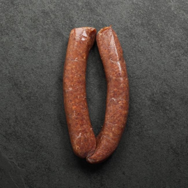 overhead view of two raw Iberico pork and cranberry sausages