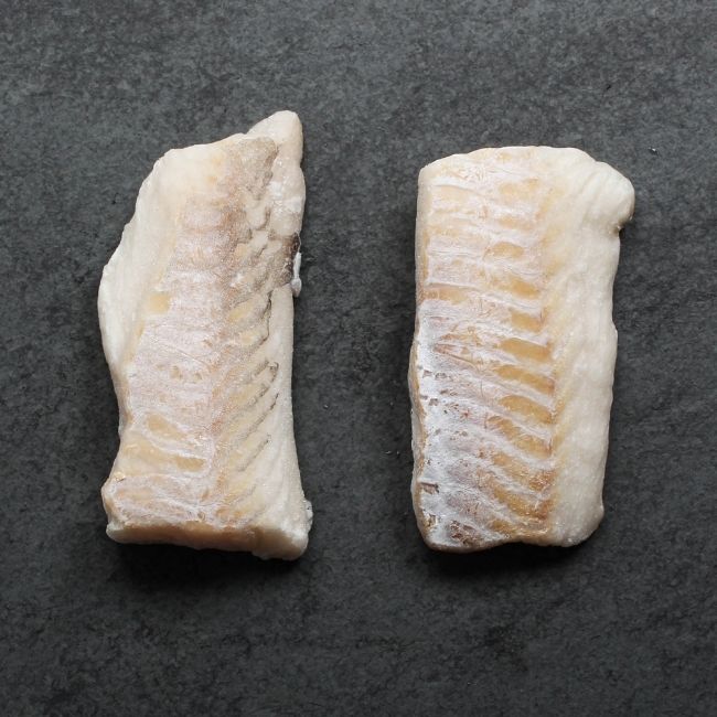 overhead view of two pieces of raw haddock filets