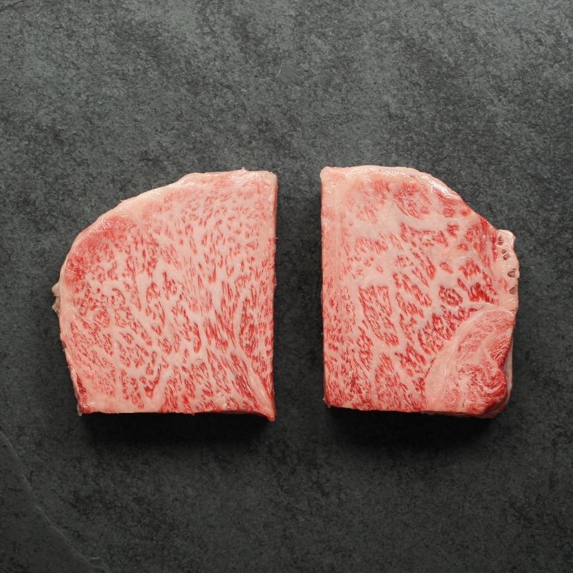 overhead view of two raw Japanese A5 wagyu New York Steaks - California cut
