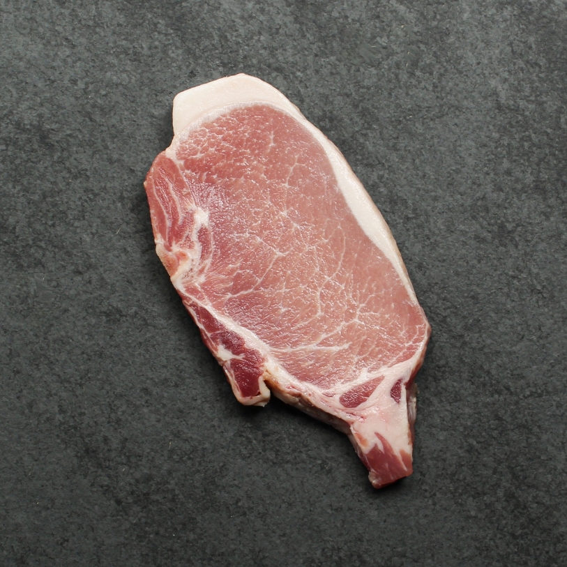 Overhead image of uncooked bone-in pork chop sourced in Canada.