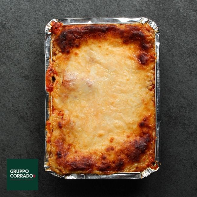 overhead view of a cooked, cheesy lasagna with crispy edges