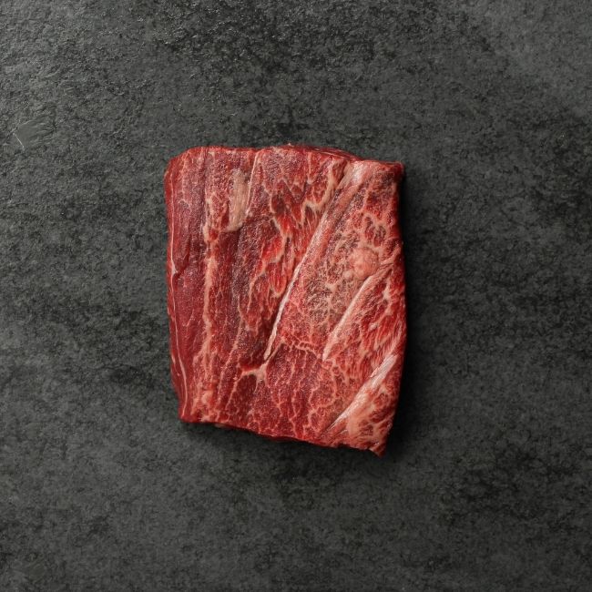 overhead view of a raw, heavily-marbled American wagyu flat iron steak