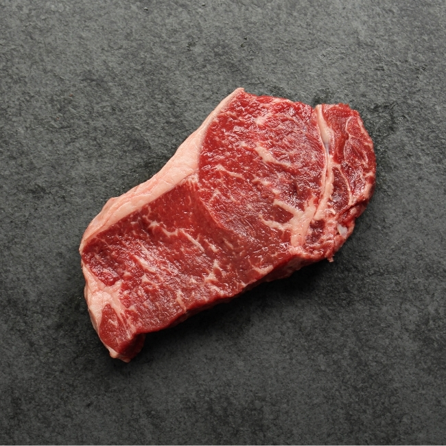 Bottom side of a raw New York steak.