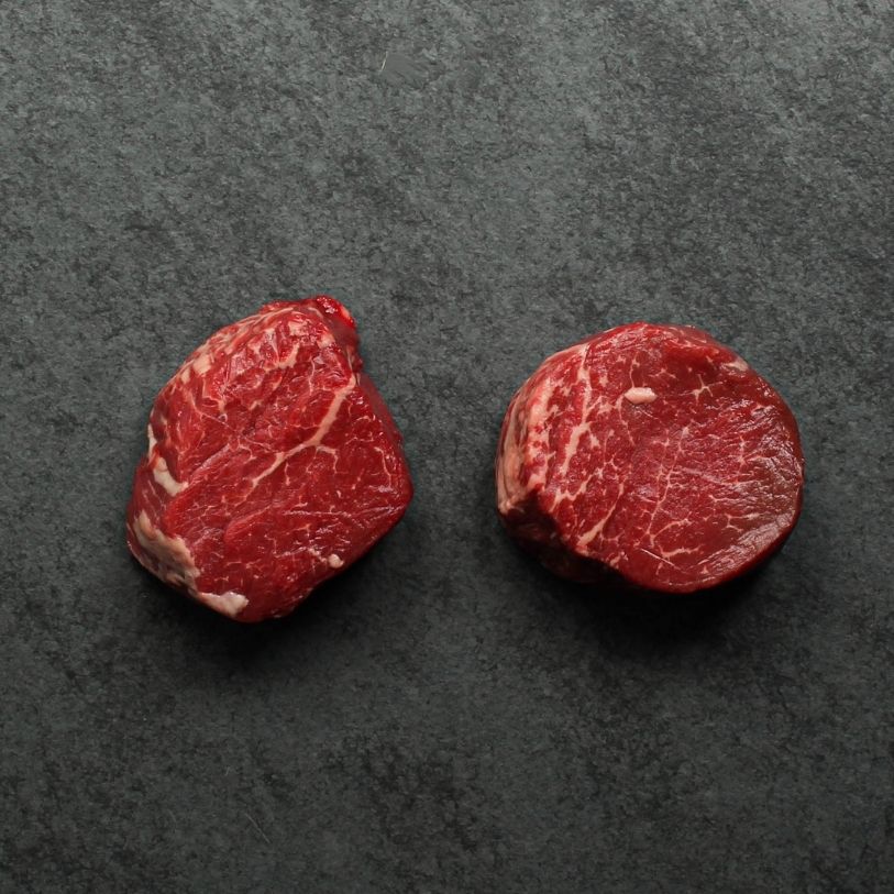overhead image of two raw beef filet mignon steaks