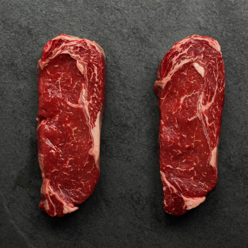overhead view of two raw Argentinian rib eye steaks