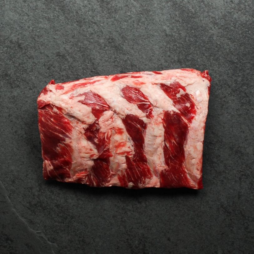 overhead view of a halved rack of raw beef back ribs