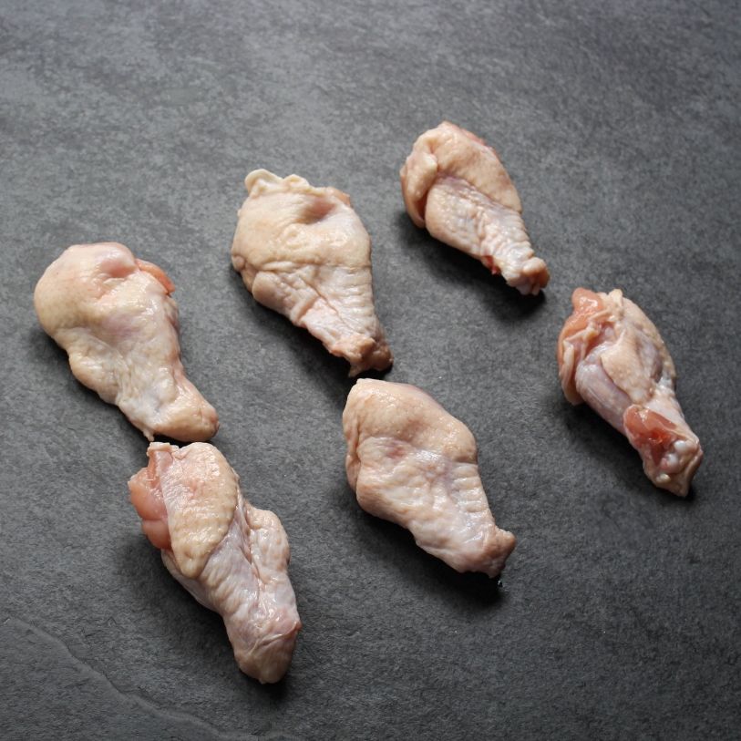 angled view of 6 raw chicken wing fryer drumette