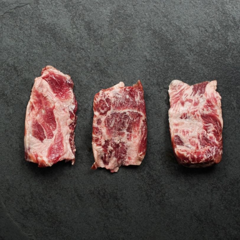 overhead view of three raw pieces of Iberico pork pluma