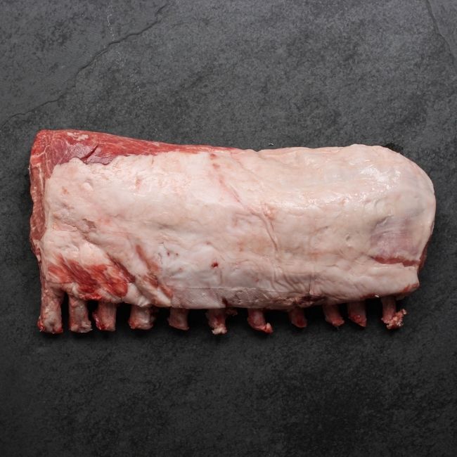 overhead view of the fatty side of a Spanish Iberico pork rack with frenched bones