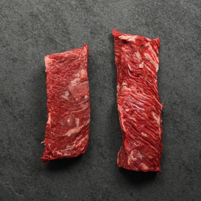 overhead view of the underside of two raw hanger steaks