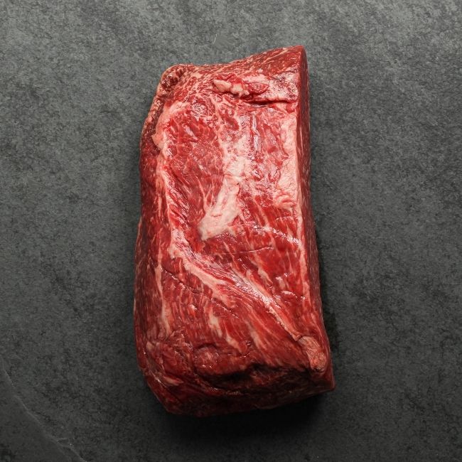overhead view of the underside of a raw wagyu beef sirloin roast