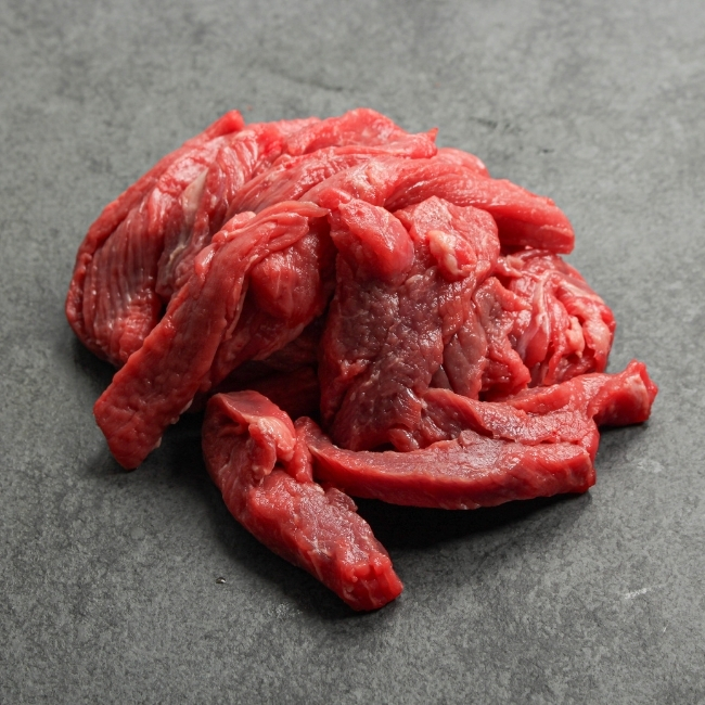 Side view of beef stir fry slices.