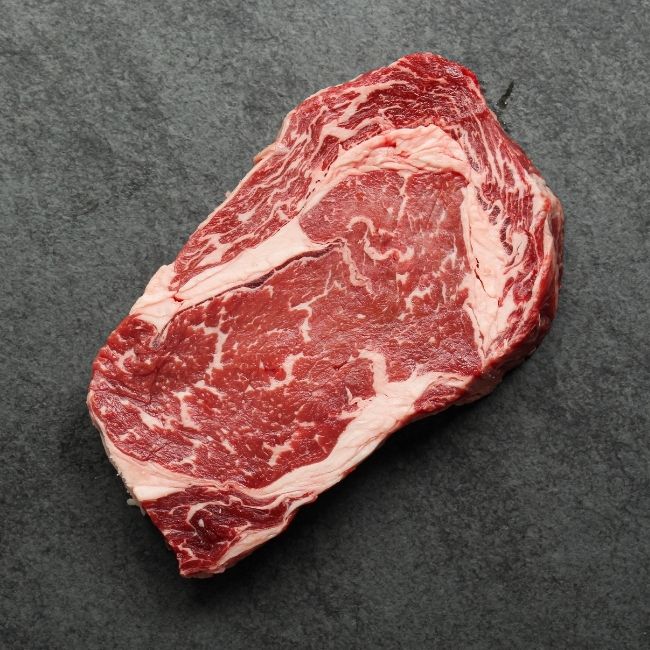 overhead view of a raw rib eye steak